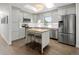 Updated kitchen with island, stainless steel appliances, skylight and light grey cabinets at 6470 Field St, Arvada, CO 80004