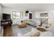 Cozy living room features stylish decor, natural light and neutral paint at 6470 Field St, Arvada, CO 80004