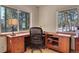 Bright home office with a large desk, ample storage, and scenic views at 23148 Pawnee Rd, Indian Hills, CO 80454