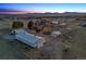 Panoramic aerial shot capturing the estate's layout, showcasing buildings, landscape, and stunning mountain backdrop at 9703 Phillips Rd, Lafayette, CO 80026