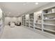 Spacious finished basement with built-in shelving and a comfortable seating area at 9703 Phillips Rd, Lafayette, CO 80026