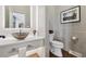 Powder room with vessel sink, unique mirror, and modern toilet at 9703 Phillips Rd, Lafayette, CO 80026