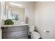Bathroom with wood vanity, granite counters, and modern fixtures at 9703 Phillips Rd, Lafayette, CO 80026