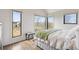 Bedroom features large windows and hardwood floors overlooking an outdoor rural landscape at 9703 Phillips Rd, Lafayette, CO 80026