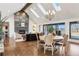 Bright dining area open to the living room, featuring a modern chandelier and ample natural light from skylights at 9703 Phillips Rd, Lafayette, CO 80026