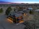 Stunning dusk view of the house, showcasing its architecture and setting within a picturesque mountain landscape at 9703 Phillips Rd, Lafayette, CO 80026