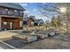 Rustic home exterior with unique design features, a garden, and mature trees at 9703 Phillips Rd, Lafayette, CO 80026