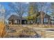 Exterior of a beautiful rustic home with mature trees and a walkway at 9703 Phillips Rd, Lafayette, CO 80026