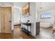Hallway view into a spacious main bedroom and bathroom with freestanding tub at 9703 Phillips Rd, Lafayette, CO 80026