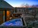 Outdoor area with a private hot tub and chairs on the wooden patio at 9703 Phillips Rd, Lafayette, CO 80026
