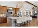 Gourmet kitchen boasts granite island, custom cabinetry, and stainless steel appliances with vaulted ceiling at 9703 Phillips Rd, Lafayette, CO 80026