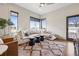 Bright living room featuring a sectional sofa, modern decor, and large windows at 9703 Phillips Rd, Lafayette, CO 80026