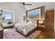 Inviting main bedroom with a bright, airy space, complemented by a serene view and stylish decor at 9703 Phillips Rd, Lafayette, CO 80026