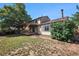 Spacious backyard with wooden deck, pergola, lawn and mature trees at 15892 E Arkansas Pl, Aurora, CO 80017