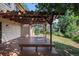 Side view of a wooden deck with pergola and built in seating, overlooking the yard at 15892 E Arkansas Pl, Aurora, CO 80017