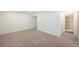 Finished basement with neutral walls, beige carpet, recessed lighting, and entrance to the bathroom at 15892 E Arkansas Pl, Aurora, CO 80017