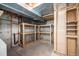 Unfinished basement area with exposed ductwork, shelving, and concrete floor at 15892 E Arkansas Pl, Aurora, CO 80017