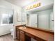 Bathroom featuring a long vanity with a large mirror, a toilet, and a shower in a separate room at 15892 E Arkansas Pl, Aurora, CO 80017
