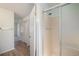 Bathroom featuring a glass shower with pink tile and a view of closet doors and the rest of the house at 15892 E Arkansas Pl, Aurora, CO 80017