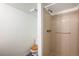 Cozy bathroom featuring a toilet with wooden seat and a neutral shower stall at 15892 E Arkansas Pl, Aurora, CO 80017