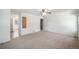 Bedroom featuring neutral walls and carpeting, ceiling fan, and doorway to another room at 15892 E Arkansas Pl, Aurora, CO 80017