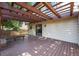 Outdoor deck area with a wooden pergola, built-in bench, and sliding glass door at 15892 E Arkansas Pl, Aurora, CO 80017