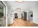 Eat-in kitchen featuring stainless steel appliances, light countertops, and wood flooring at 15892 E Arkansas Pl, Aurora, CO 80017