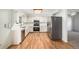Well-lit kitchen with stainless steel appliances, light countertops, wood floors, and ample storage at 15892 E Arkansas Pl, Aurora, CO 80017