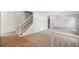 Bright living room featuring neutral carpet, stairway, and open layout at 15892 E Arkansas Pl, Aurora, CO 80017