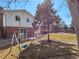 Wide backyard featuring a swing set and tree. The lawn is perfect for recreation at 2165 S Flower St, Lakewood, CO 80227