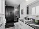 Modern bathroom featuring a stylish vanity with black countertop and glass-enclosed shower at 2165 S Flower St, Lakewood, CO 80227