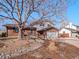 Charming two-story home with brick and siding exterior, landscaping, and a two car garage at 2165 S Flower St, Lakewood, CO 80227