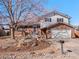 Charming two-story home with brick and siding exterior, landscaping, and a two car garage at 2165 S Flower St, Lakewood, CO 80227