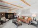 Inviting living room featuring exposed beams, a fireplace, and comfortable seating at 2165 S Flower St, Lakewood, CO 80227