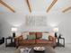 Cozy living room with exposed beams, a leather sofa, and stylish decor at 2165 S Flower St, Lakewood, CO 80227