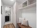 Well-organized mudroom with built-in storage, a bench, and access to a half bathroom at 2165 S Flower St, Lakewood, CO 80227