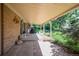 Covered patio overlooking a landscaped backyard with trees and plants at 6780 Allison St, Arvada, CO 80004