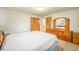 Bedroom with light carpet, closet, and matching vanity/dresser combo at 6780 Allison St, Arvada, CO 80004