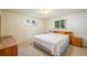 Bright bedroom with carpet, two windows, and matching bedside tables at 6780 Allison St, Arvada, CO 80004