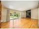 Spacious living room with hardwood floors, fireplace, and sliding glass doors to the backyard at 6780 Allison St, Arvada, CO 80004
