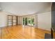 Spacious living room featuring hardwood floors, fireplace, and sliding glass doors to the backyard at 6780 Allison St, Arvada, CO 80004