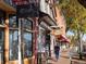 Charming street with storefronts and mature trees at 6780 Allison St, Arvada, CO 80004