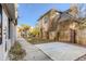 Home's backyard includes a concrete patio and mature trees at 1839 Grove St, Denver, CO 80204