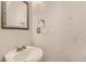 Close-up of half bathroom with a decorative mirror and pedestal sink at 1839 Grove St, Denver, CO 80204