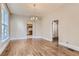 Open dining room with hardwood floors, a chandelier, and doorway view to the kitchen at 1839 Grove St, Denver, CO 80204