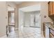 Bright kitchen features tile floor and French doors leading to backyard at 1839 Grove St, Denver, CO 80204