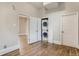 Laundry room with stackable washer and dryer in an open closet, with hardwood floors at 1839 Grove St, Denver, CO 80204