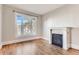 Bright living room featuring a decorative fireplace and a large window with natural light at 1839 Grove St, Denver, CO 80204