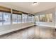 Sunroom features wood-look floors and wall-to-wall windows at 1839 Grove St, Denver, CO 80204