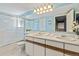 Bright bathroom featuring a double vanity, well-maintained fixtures, and a shower over tub at 19937 E Loyola Pl, Aurora, CO 80013
